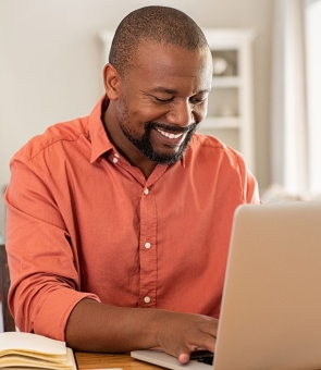 Happy mature man using laptop