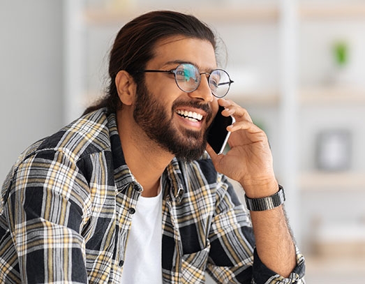 man on couch having phone talk